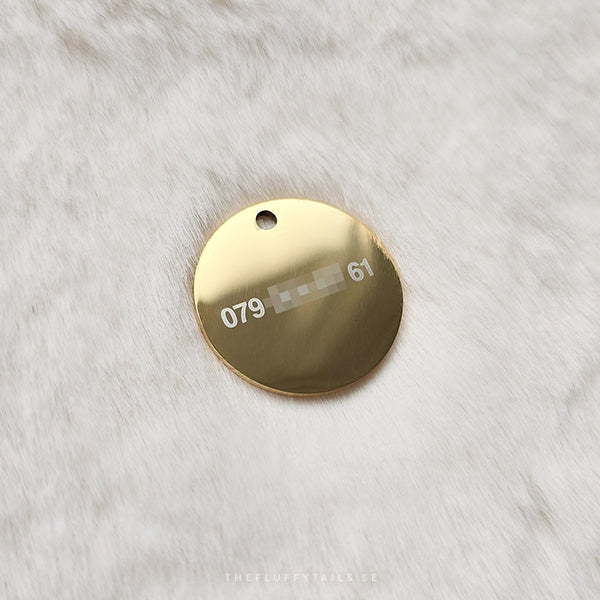 Rund guldig namnbricka med telnr baksida