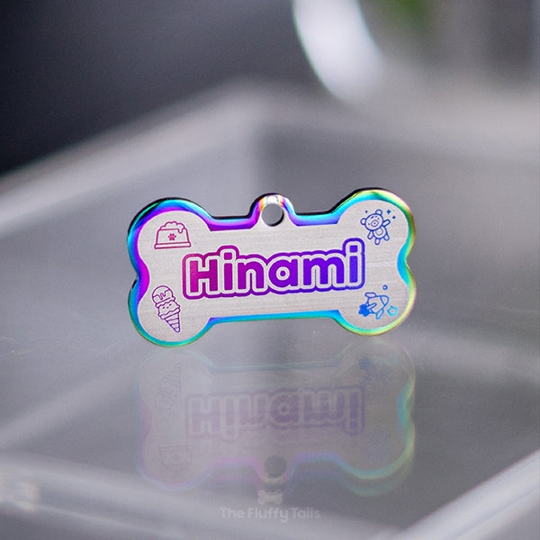 Hundbensformad namnbricka för hund och katt, i regnbågens olika färger med söta, dekorativa ikoner av nalle, glass, rymdraket och fylld hundmatskål